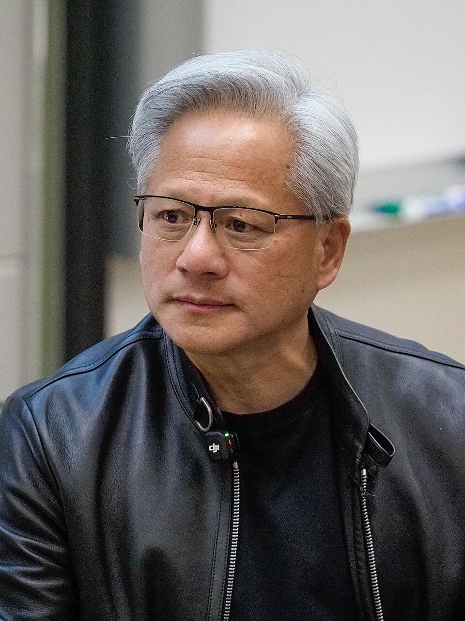 Jensen Huang wearing glasses and a black leather jacket.