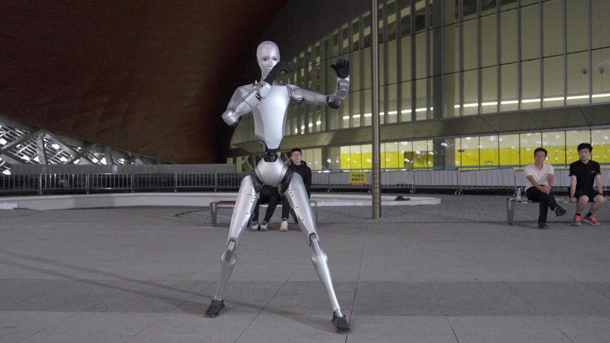 Unitree H2 humanoid robot standing in a large hall